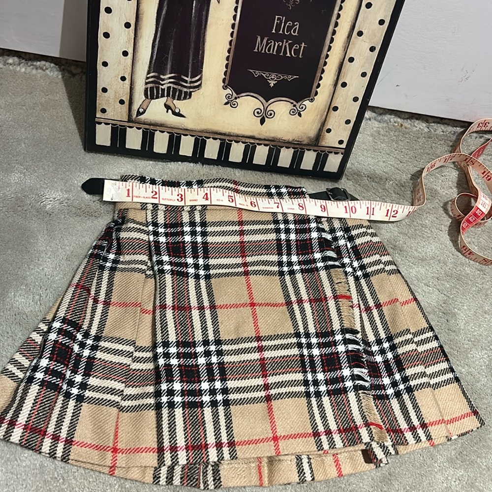 Toddler plaid skirt measures approximately 10 1/2 inches across the waist. - Picture 2 of 8